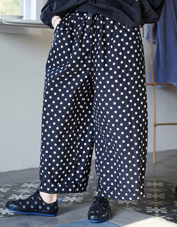 Women wearing navy blue polka dot linen pants with wide leg and elastic waist