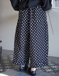 Back view of loose fit polka dot linen trousers for women