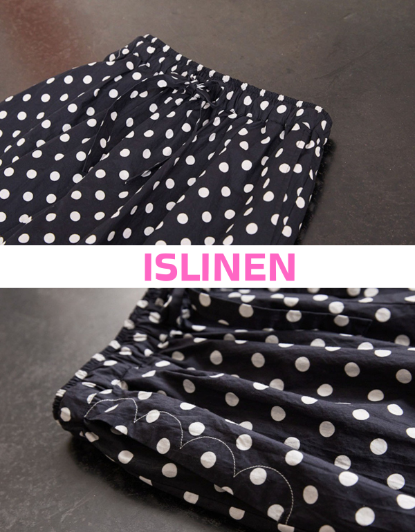 Close-up of navy polka dot linen pants showing breathable fabric texture