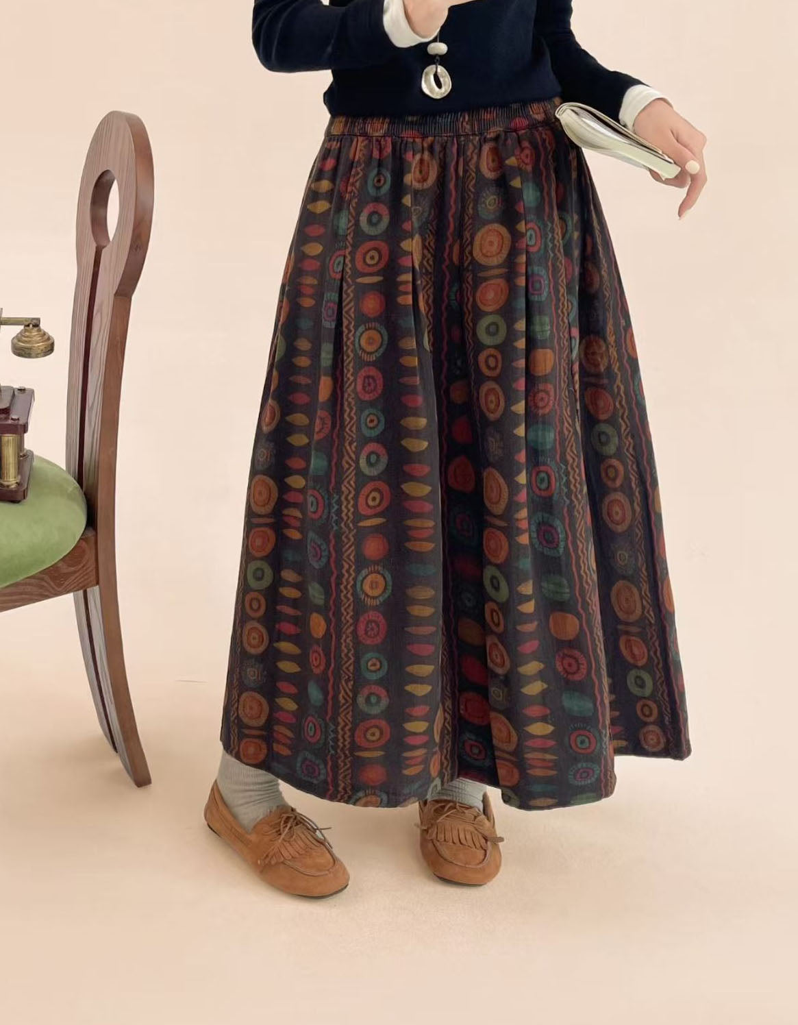 Elastic waistband and pleat detail on coffee polka dot midi skirt