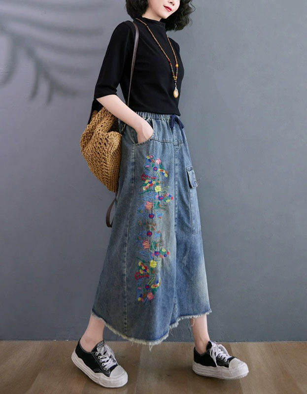 Side view of women’s embroidered denim midi skirt