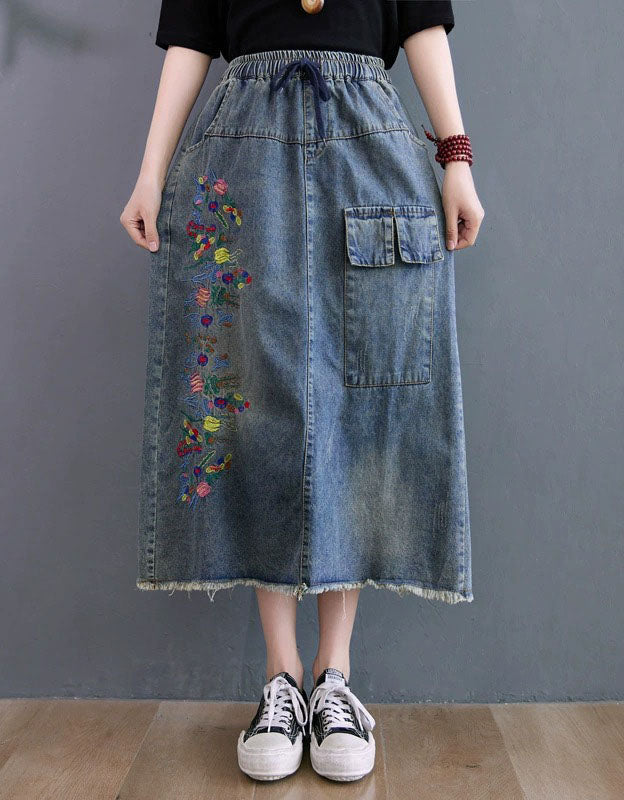 Front view of vintage embroidered denim midi skirt with elastic waist and relaxed fit