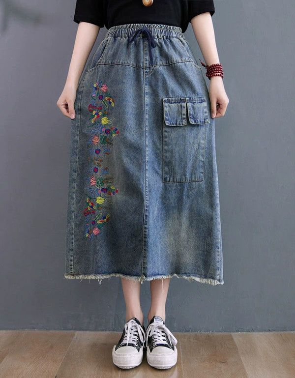 Front view of vintage embroidered denim midi skirt with elastic waist and relaxed fit