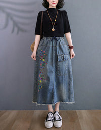 Women wearing relaxed fit denim midi skirt with floral embroidery