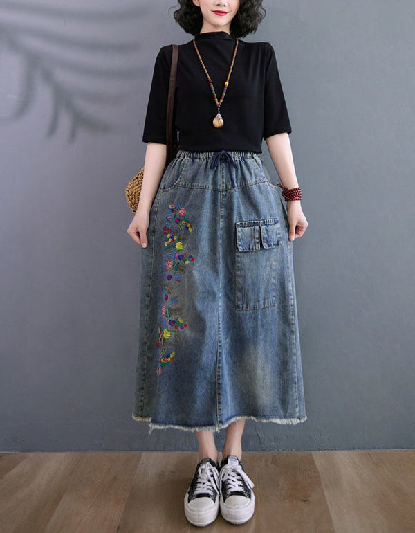 Women wearing relaxed fit denim midi skirt with floral embroidery