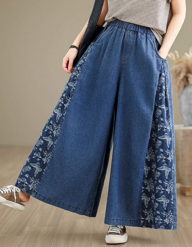 Side view of relaxed fit wide-leg denim pants with floral detailing for women