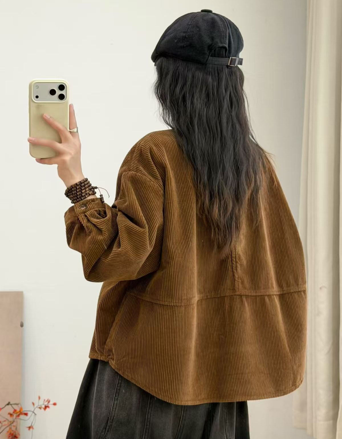 European woman wearing oversized burgundy corduroy shirt