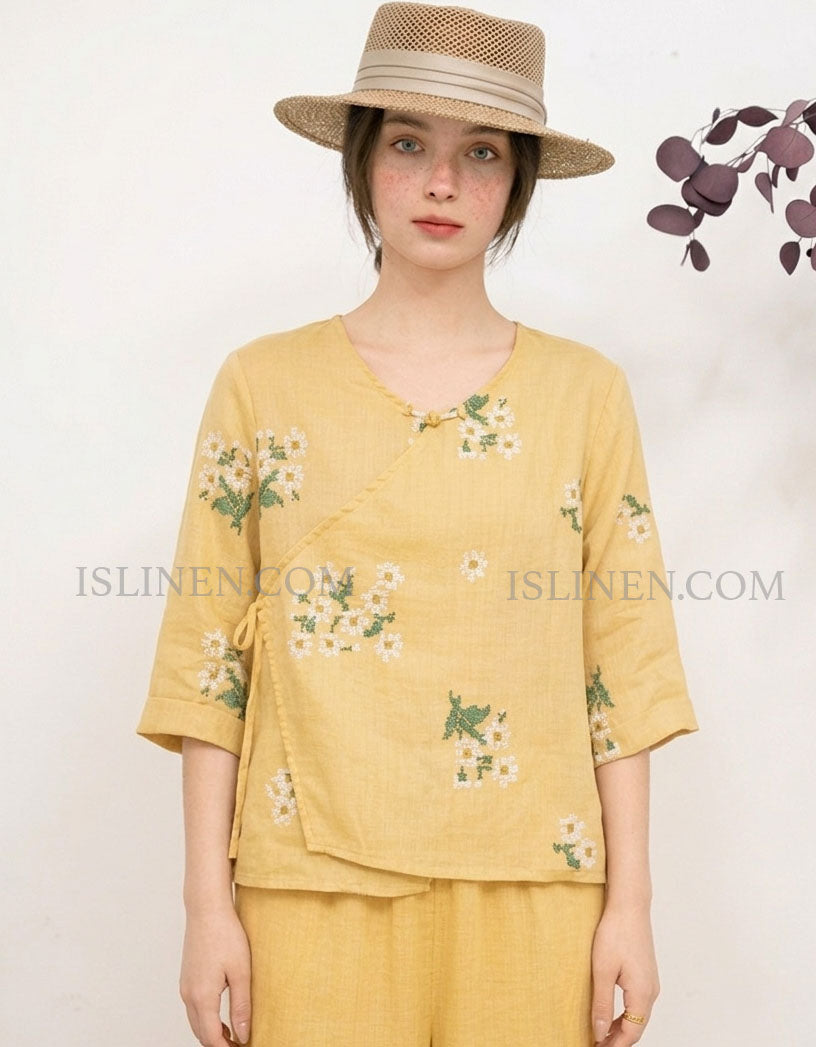 Women yellow linen blouse featuring floral embroidery and wrap style design