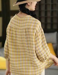 Back view of model wearing oversized yellow plaid shirt with relaxed fit