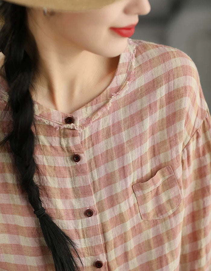 Button detail close-up of pink checkered cotton shirt
