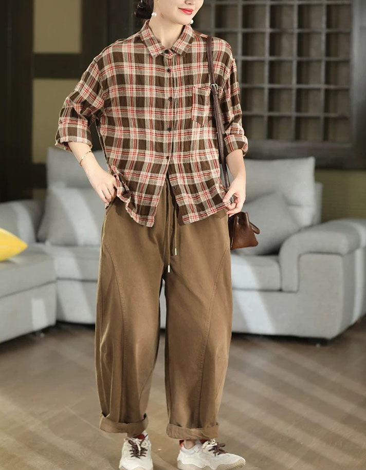 Women’s oversized brown plaid shirt side view with long sleeves and relaxed fit