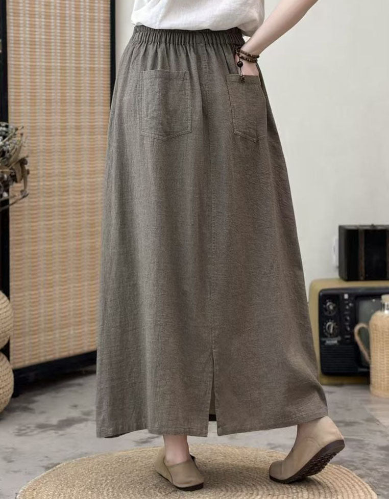 Women’s long plaid skirt styled with casual top and flats