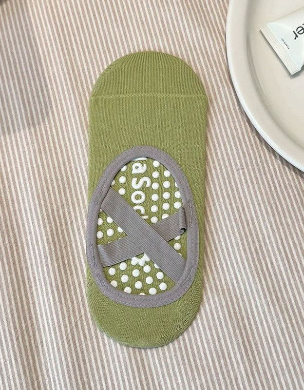 women wearing non slip yoga socks with elastic strap