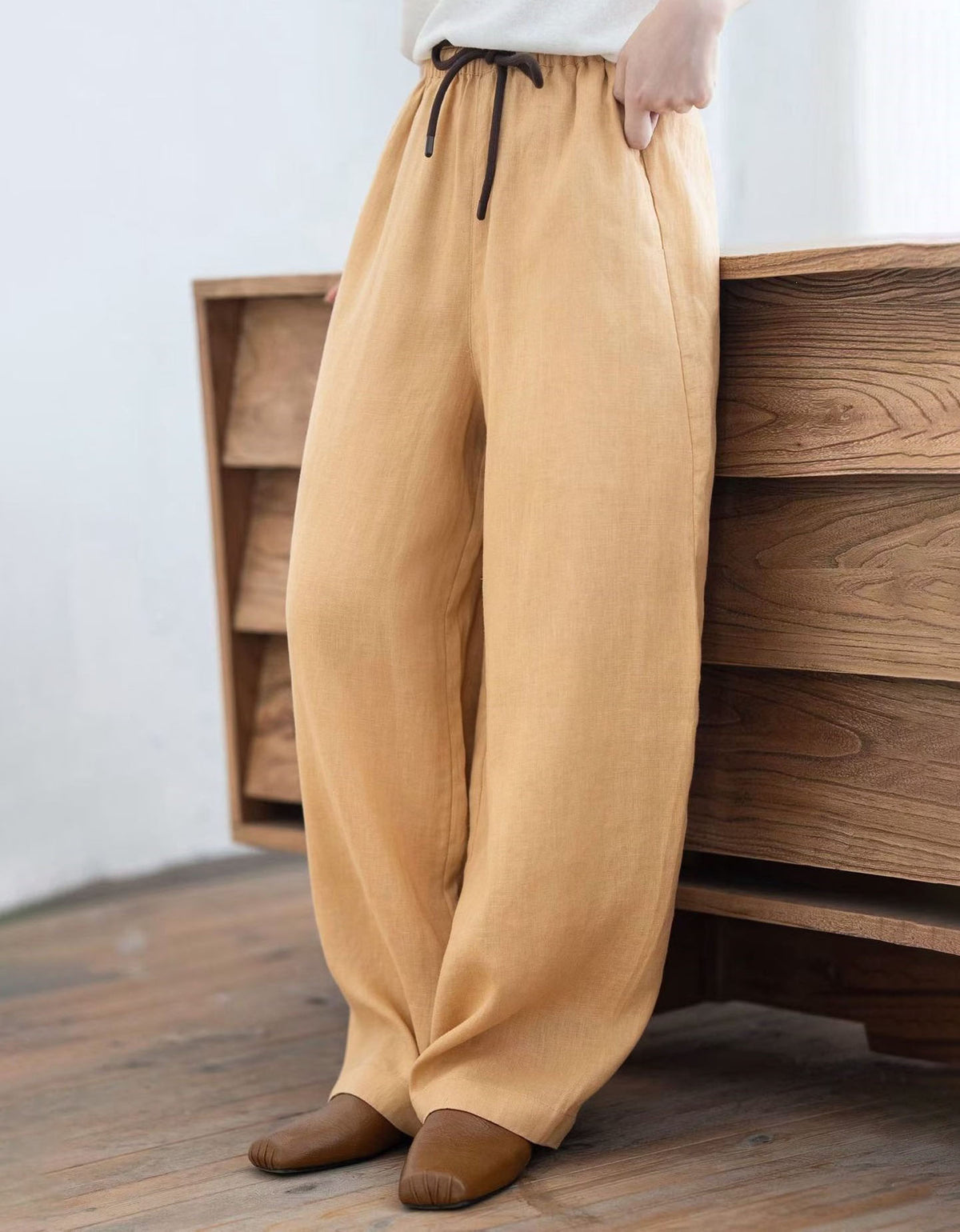 Minimalist wide leg linen pants styled with brown flats for casual spring and summer outfits