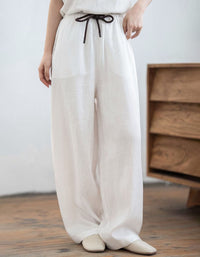 Women's mustard yellow linen wide leg pants with elastic drawstring waist and relaxed loose fit silhouette