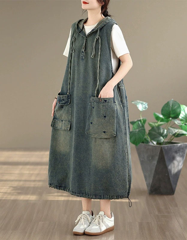 Side view of loose denim hoodie dress paired with sneakers
