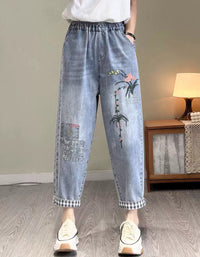Women's embroidered floral denim jogger pants with elastic waist and cuffed hem