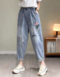 Front view of relaxed fit floral embroidery denim jogger pants for women