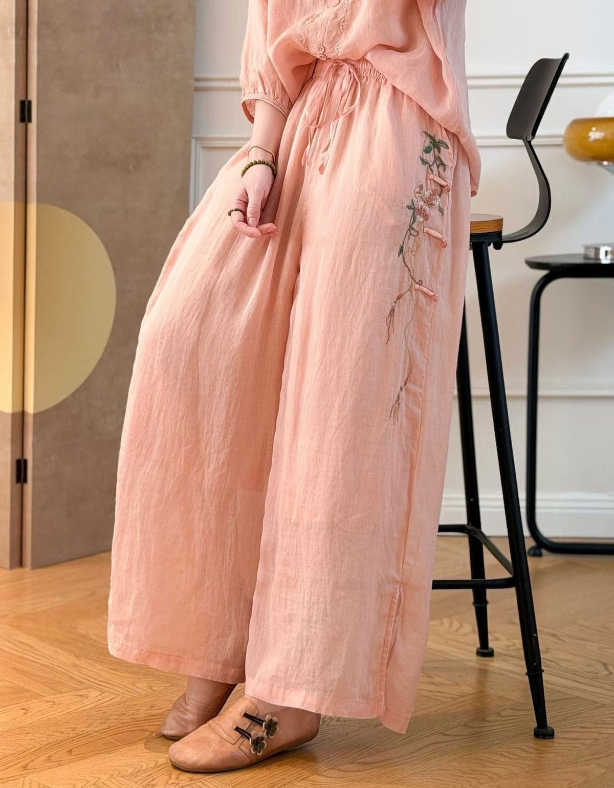 Women’s flowy palazzo pants featuring side floral embroidery detail