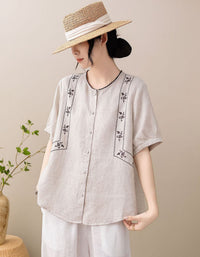 Front view of women's embroidered linen blend short sleeve blouse