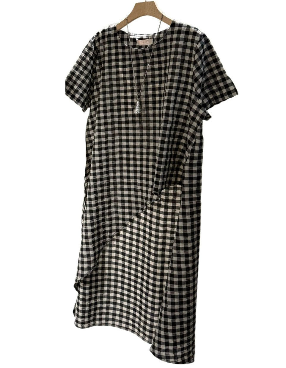 Front view of women's black-and-white asymmetrical check dress