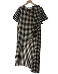 Front view of women's black-and-white asymmetrical check dress