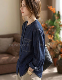 Vintage wash blue denim top with relaxed silhouette and long sleeves