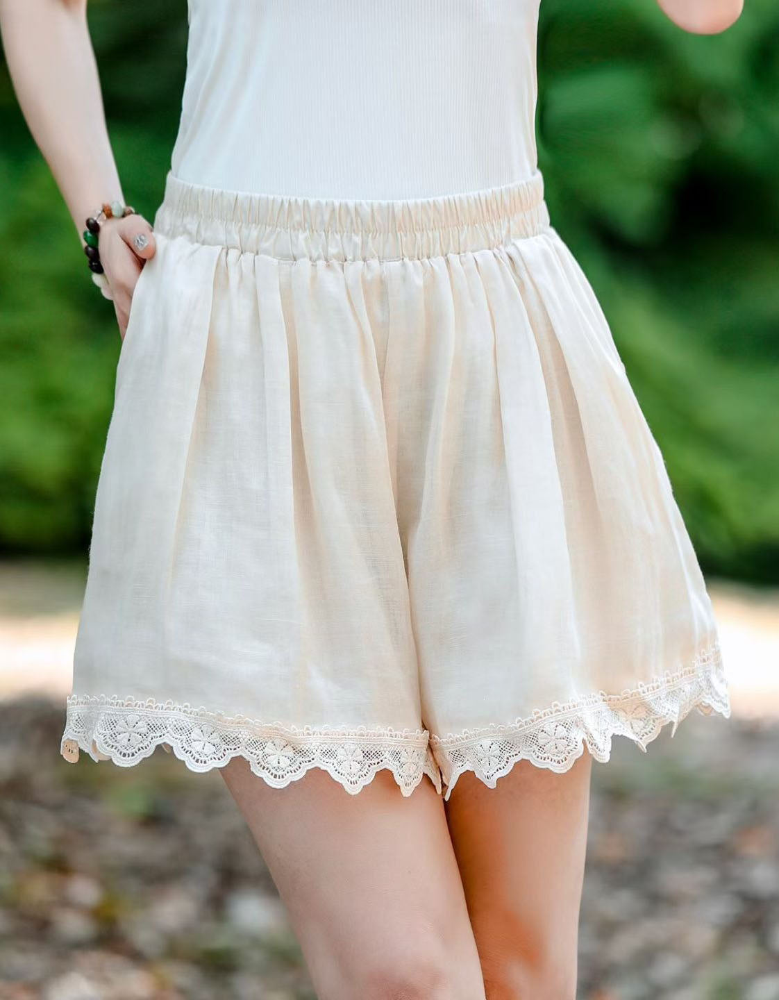 Women’s blush pink linen blend shorts with elastic waistband and lace trim hem