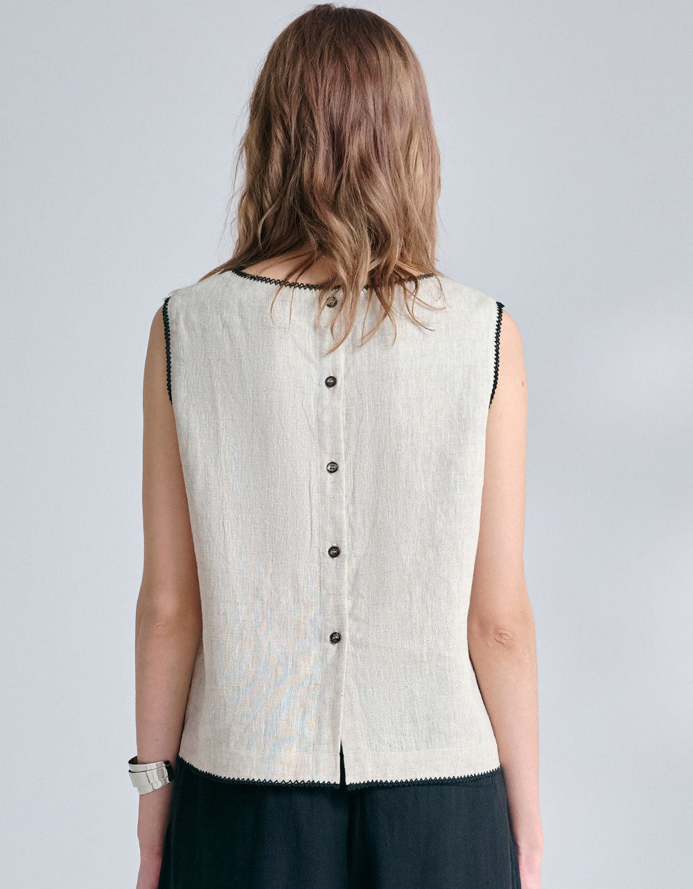 Women wearing minimalist sleeveless linen tank top in neutral beige color