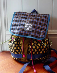 Top view of open mini plaid backpack showing small storage space for daily essentials