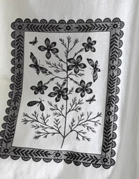 Close up of vintage botanical artwork on soft white graphic t-shirt