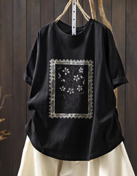Front view of black oversized floral graphic t-shirt with vintage botanical print

