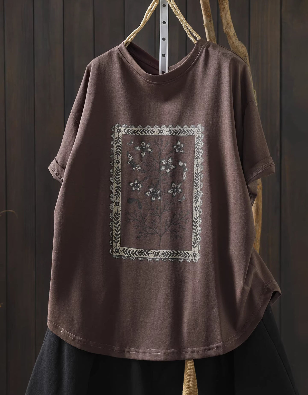Front view of coffee oversized floral graphic t-shirt with vintage botanical print

