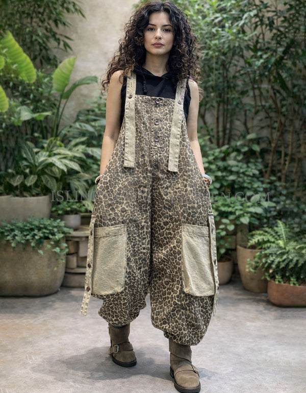 Front view of loose leopard bib overalls styled with black top