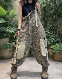 Person wearing leopard print patchwork pants in an outdoor setting with plants.