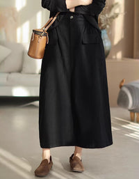 Women’s black cotton midi skirt featuring side pockets and button closure