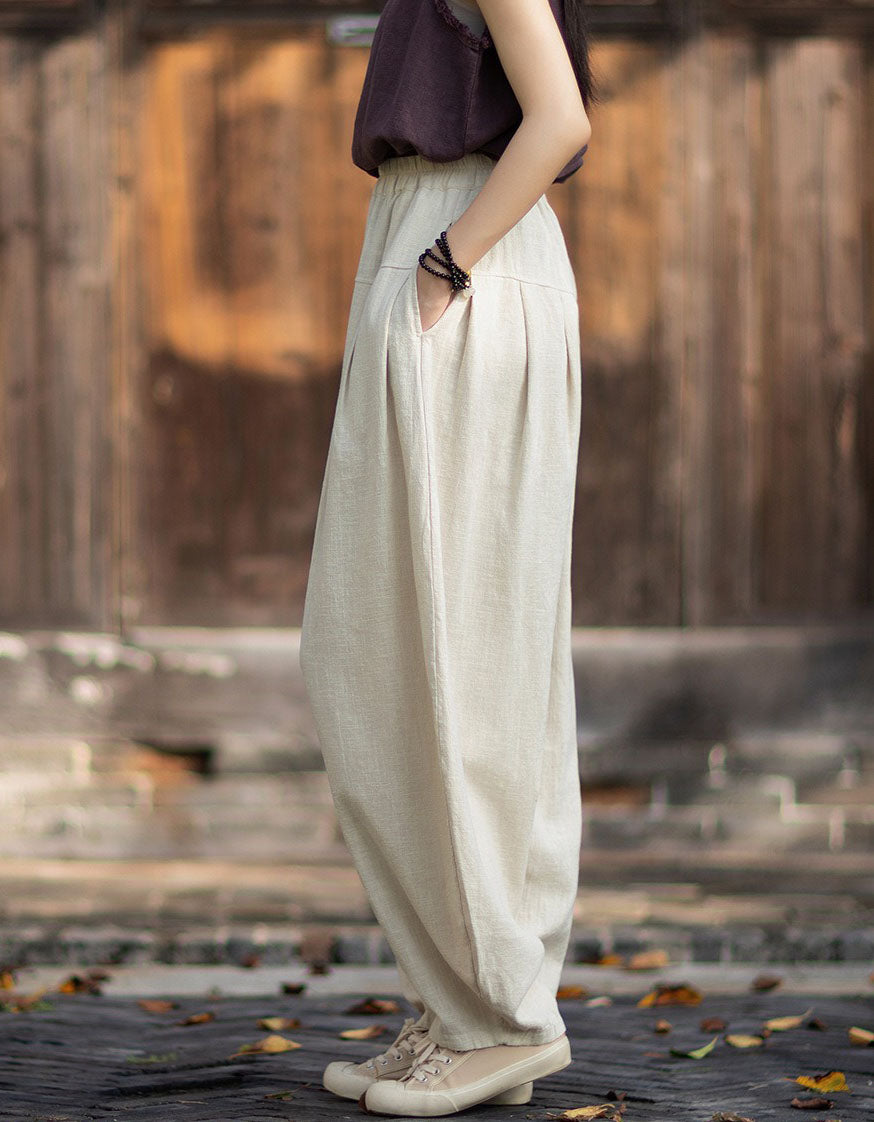 Side view of linen harem pants with gathered waistband and loose draped legs.