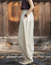 Side view of linen harem pants with gathered waistband and loose draped legs.