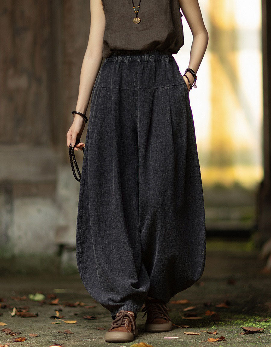Black linen lantern pants showing wide leg shape and relaxed high waist.