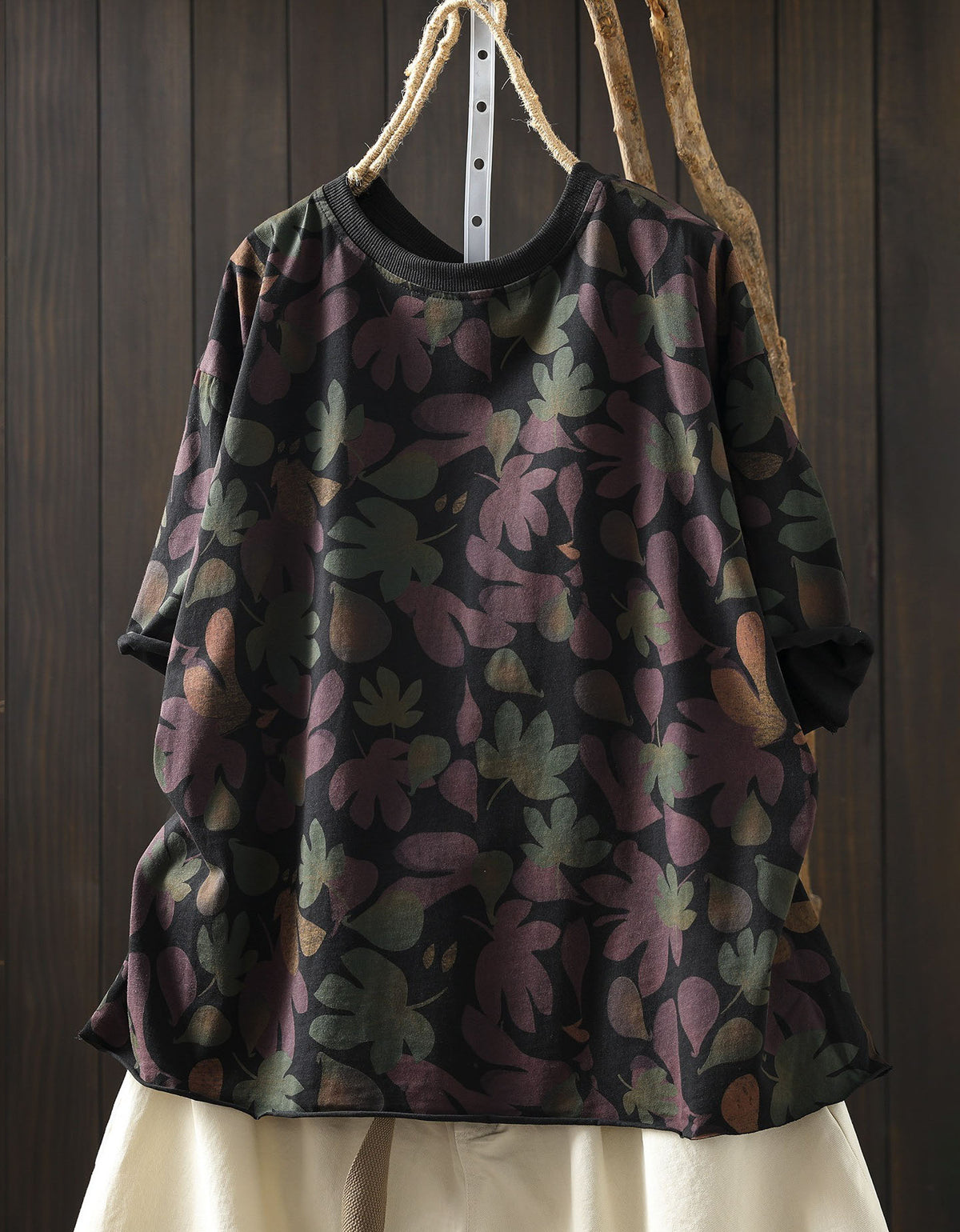 Black oversized cotton top with green and yellow floral print, front view