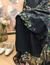 Detailed view of floral pattern and gathered waist design on vintage-inspired midi dress