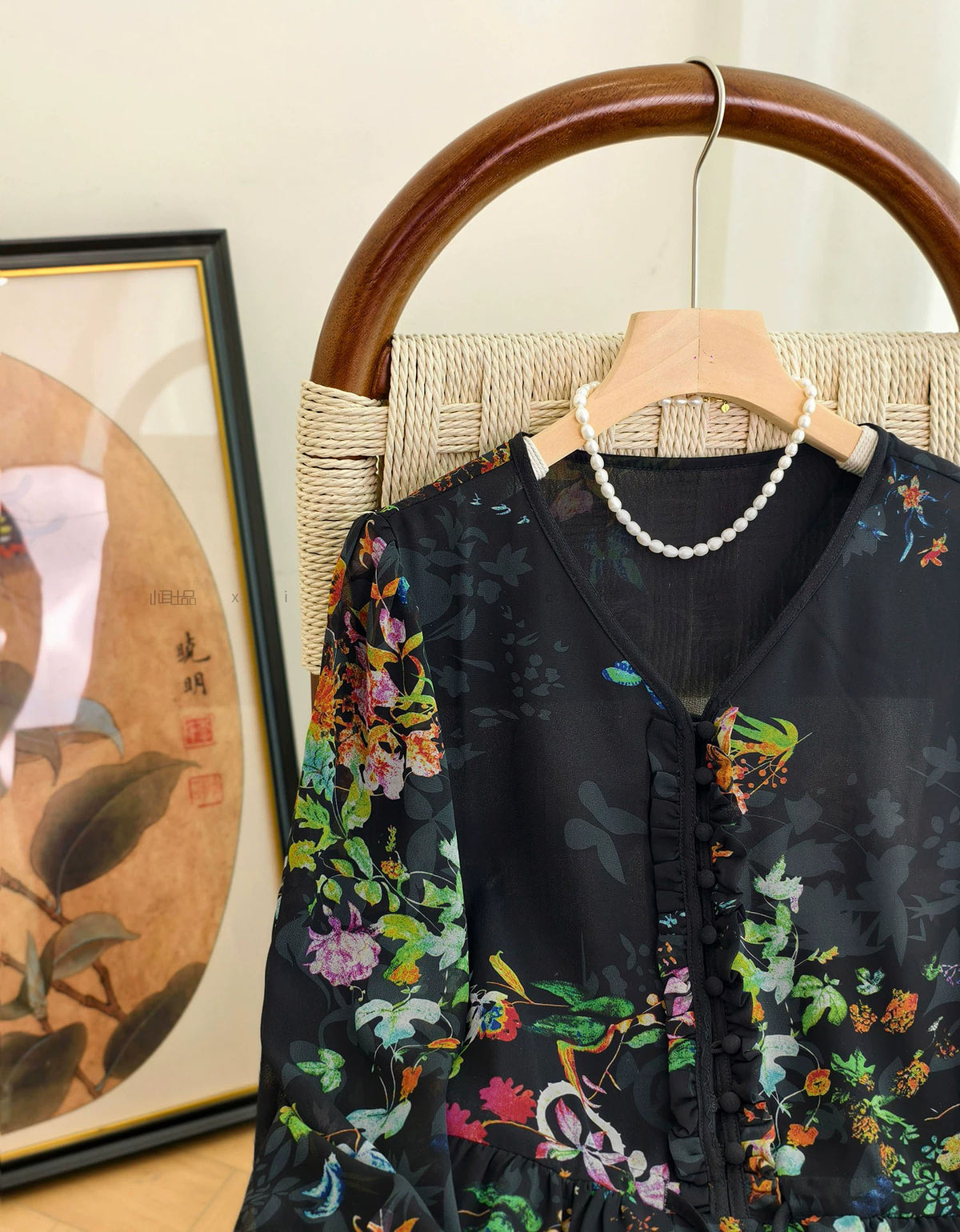 Front view of women's black floral midi dress featuring long sleeves and lightweight chiffon fabric