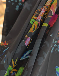 Back view of women's vintage floral midi dress with long sleeves and airy silhouette