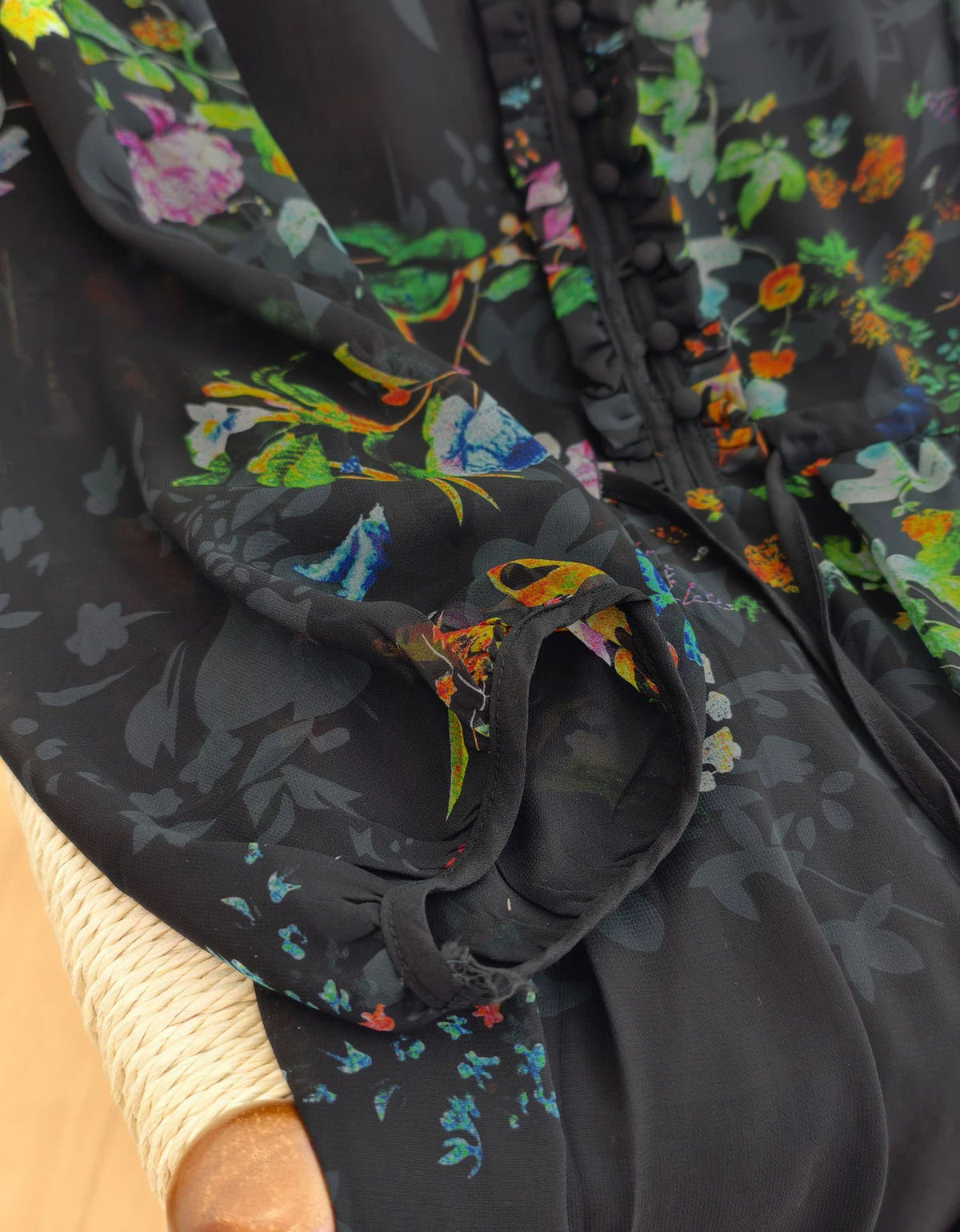 Close-up of colorful floral print chiffon fabric on women's bohemian midi dress