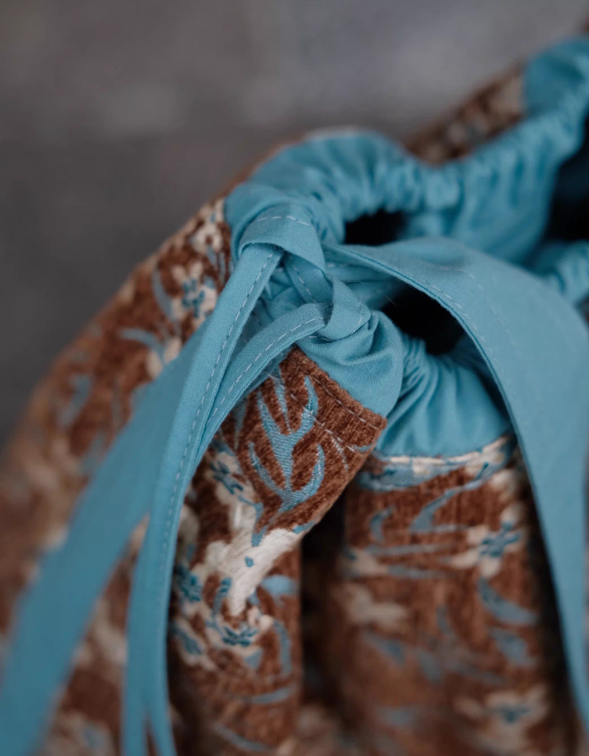 Women’s boho fabric handbag with earthy flower pattern and long straps