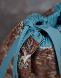Women’s boho fabric handbag with earthy flower pattern and long straps
