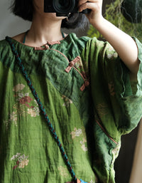 Women's vintage green linen blouse with floral print and traditional frog button closure