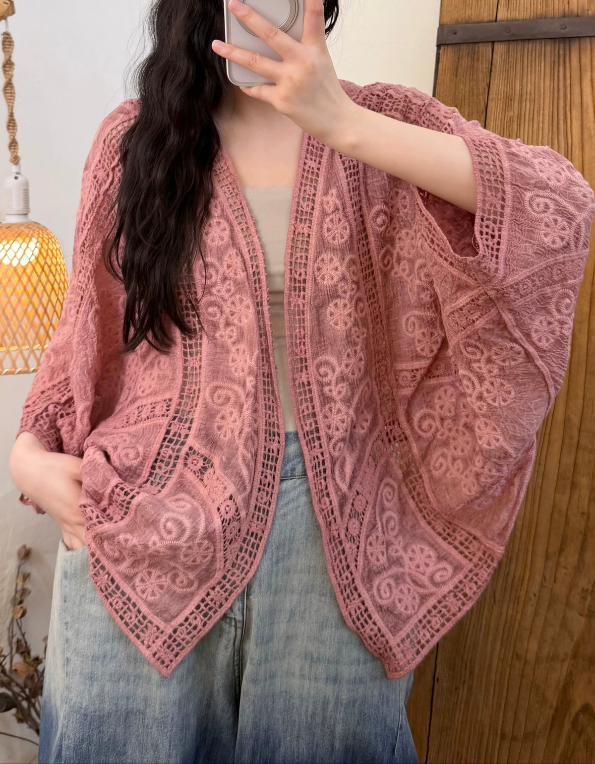 Oversized crochet kimono outerwear paired with denim jeans