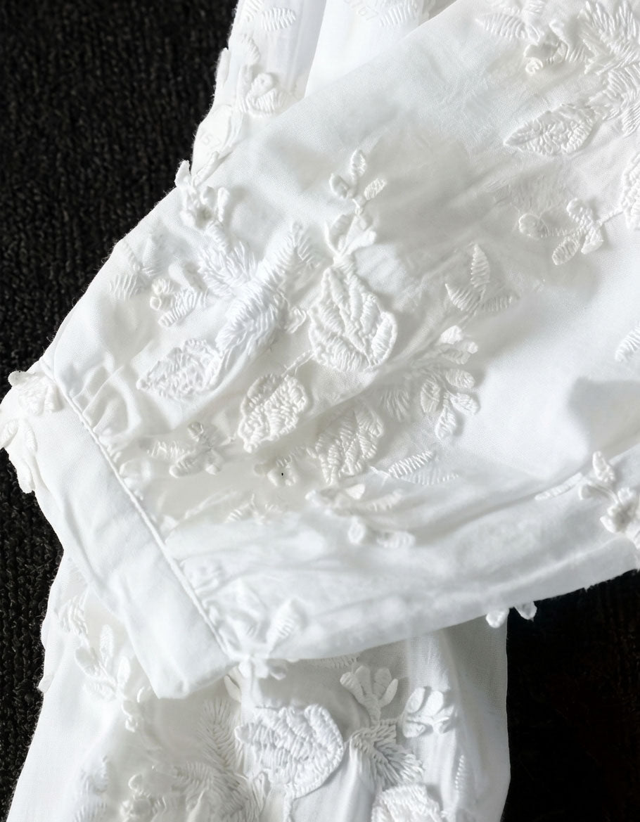 Boho style white embroidered top with relaxed silhouette and soft cotton material