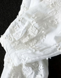 Boho style white embroidered top with relaxed silhouette and soft cotton material